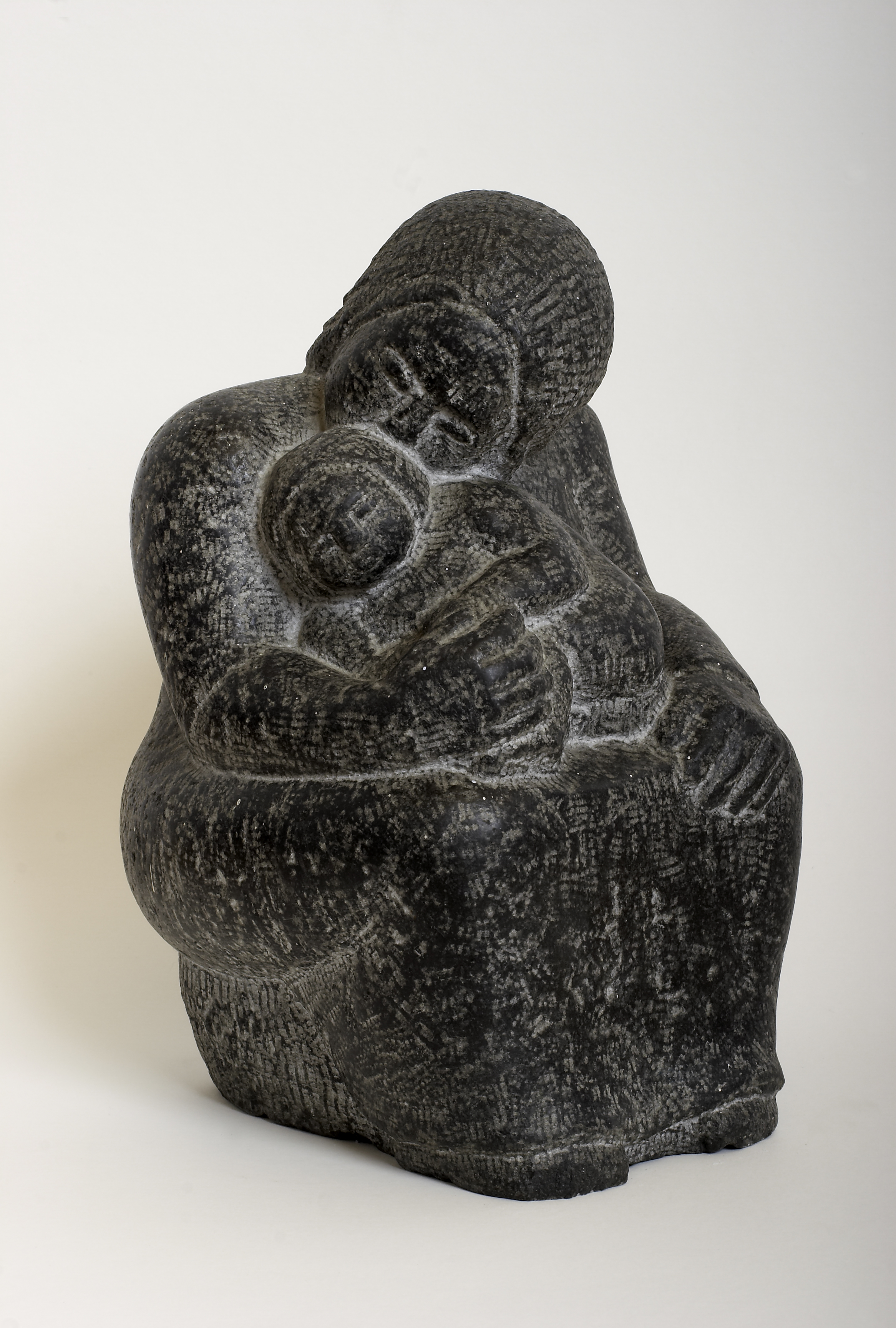 Carved limestone on a fossilised slate base