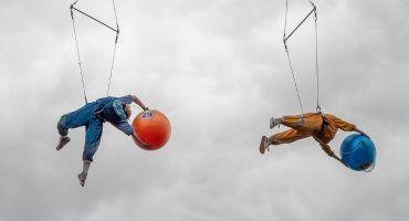 an image of two acrobats suspended in the air