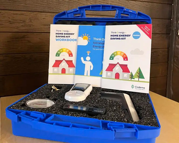 image of a blue container holding the contents of a Codema Home Energy Saving Kit, including accompanying information and workbook brochures
